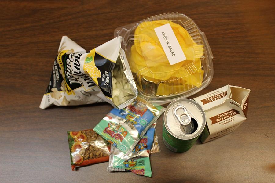 Of all the waste in this photo, only the popcorn and snack wrappers belong in the trash. The food and paper is compostable and the can, milk carton and sandwich box are recyclable. Earth Corps is working hard to educate students on how to sort their food.