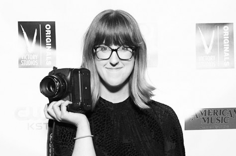 Abby Williamson poses outside of the studio with her favorite camera in hand.