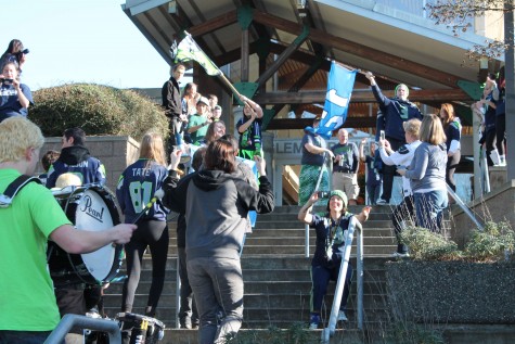 Students parade on the main staircase during the Seahawks assembly on Jan. 30. The entire event demonstrated the spirit of Inglemoor, as enthusiastic fans dressed up in full blue and green attire and brought flags, hats and jerseys to show their support. It shows the power of a strong fan-base, a power that will hopefully carry over to the upcoming playoffs in which all five sports could send athletes to state.