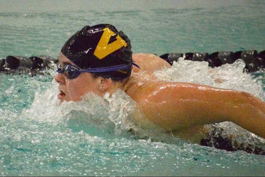Senior Calista Skog takes a breath during the 100-yard butterfly event against Lake Washington High School. She finished in first place with a time of 1:00:06, helping secure the team’s narrow victory.