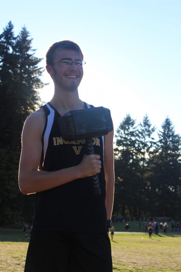 Senior team captain and hammer bearer Michael Dymek carries the hammer during the meet against Skyline and Bothell on Oct. 5. Dymek’s brother had been the hammer bearer in 2013. Inglemoor went on to place second in both boys and girls at the meet.