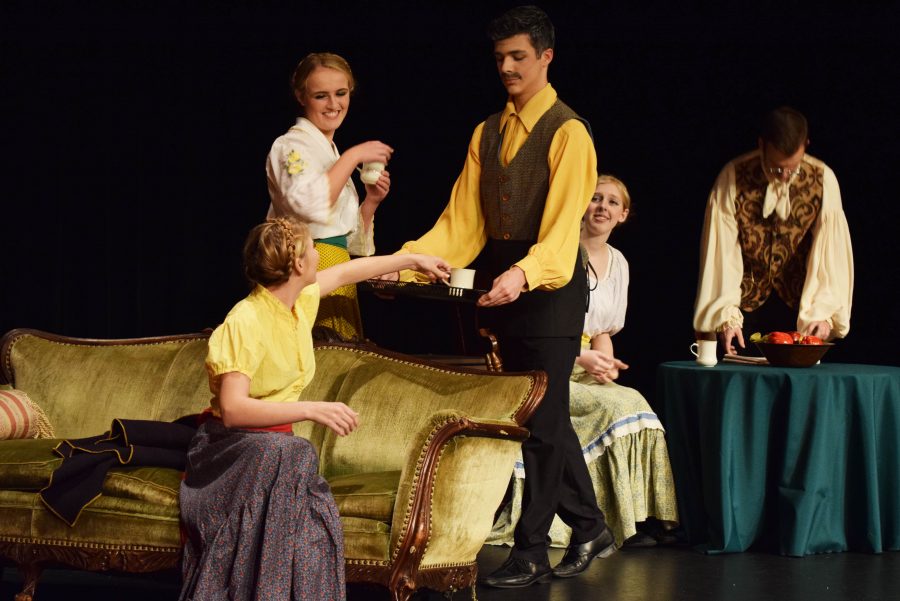 Mr. Dawson (Jacob Krieger) offers hot cider to the three dancers (Grace Hammarlund, Maddie Swift, Jessica Sparks-Stuht) after their night at the theater, while the Actor (Garrett Stanley) reads the paper.  
Photo by Parker Albin