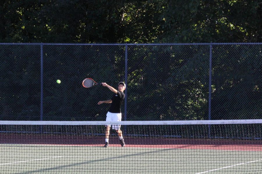 Senior James Peng practices his swing. A lot of sports in high school are team sports,  Peng said. You only require your maximum concentration for part of the time. But with tennis, especially singles, you have to be fully focused and composed the whole time.