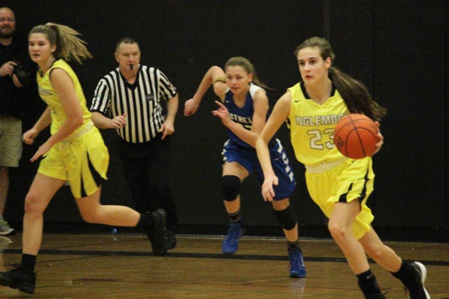 Junior Jenna Troy (far right) races downcourt against rival, Bothell High Schol. The Vikings earned a 76-58 victory. 