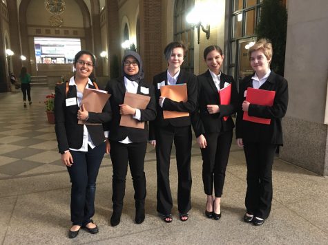 Left to right: All smiles in their matching outfits, Ishika Kaushik, Andhisty Mahmud, Ally Ellet, Priya Hendry and Sophia McDaniel walk into the Federal Reserve Building of New York to compete in the Euro Challenge. After their presentation, the girls toured around New York City. 