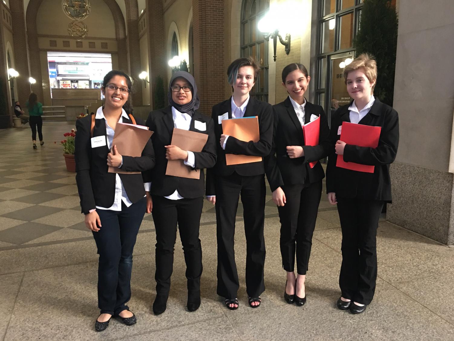 Left+to+right%3A+All+smiles+in+their+matching+outfits%2C+Ishika+Kaushik%2C+Andhisty+Mahmud%2C+Ally+Ellet%2C+Priya+Hendry+and+Sophia+McDaniel+walk+into+the+Federal+Reserve+Building+of+New+York+to+compete+in+the+Euro+Challenge.+After+their+presentation%2C+the+girls+toured+around+New+York+City.+
