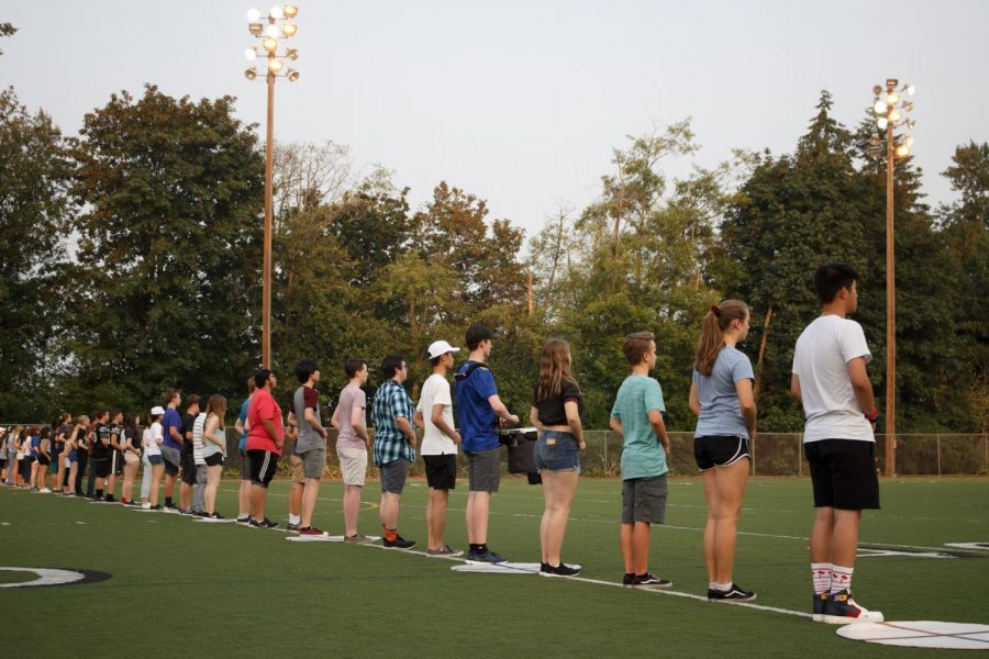 Band students line up to practice marching. Something thats really important about marching band is looking coordinated and united, senior Ethan Mah said. So having everybody be able to perform the exact same way is what makes it look so clean.