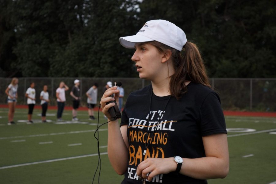 Senior drum major Beatrice Duchastel gives orders as she leads the group through drill downs. For all of marching season, Im going to be conducting, Duchastel said. Its a lot of responsibility but I love doing it.