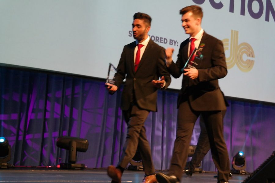Senior Rajbir Singh and senior Tom Mikolyuk walk off the stage after receiving 6th place in Digital Video Production.
