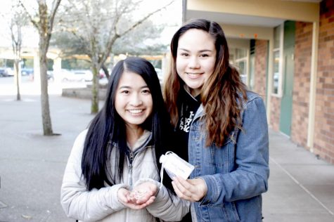 Kendyl Santiago and Cynthia Tan hold up the rings they make for SolClarity.