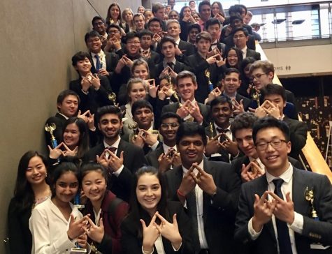 Students hold up the DECA symbol at Meydenbauer Center.