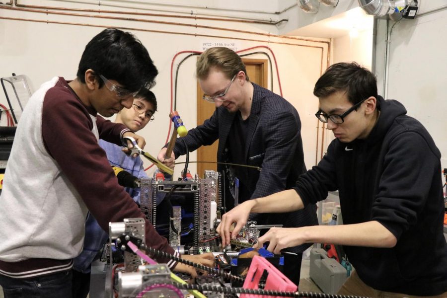 Jones works on the scoring mechanism on this teams robot before the FTC State Championships on March 17.