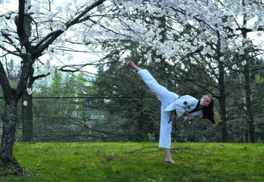 Eva Taylor shows off her sidekick. “There’s a lot [more] that’s behind the black belt than just the ability to fight,” Taylor said. She said that students must also be smart, focused and devoted to the sport earn this belt.