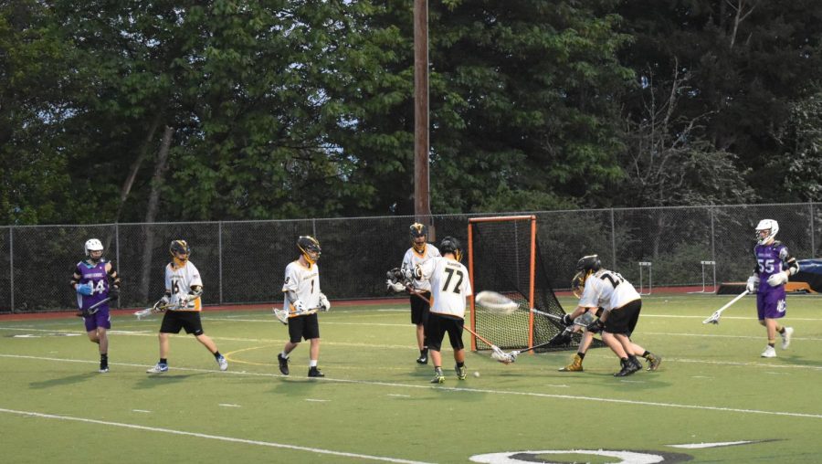 Vikings lacrosse players recover the ball at a game against North Creek High School. 