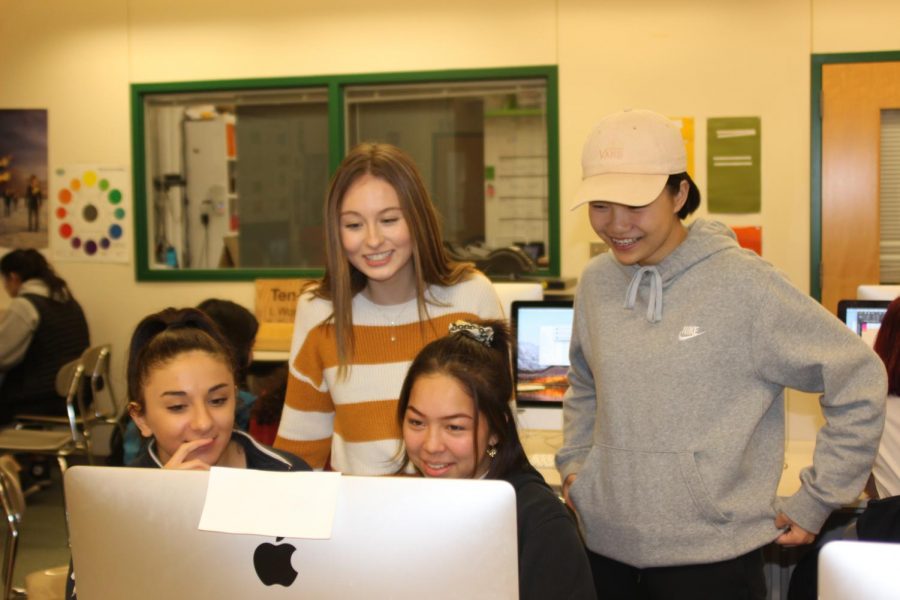 Juniors Anita Macagno, Tenny Larsen, Jessica Carbaugh and Sophia Zeng (Left to right) collaborate on a page layout. The team works on an upcoming publishing deadline. Photo by Rory Knettles
