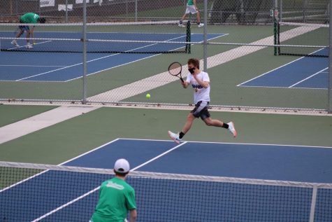3rd doubles player Cosmo Anthony-Mostad hits a forehand during the Woodinville match. The match was lost after a close tiebreak, ending 6-2, 2-6, and 7-10. Photo courtesy of Jim Orr.  