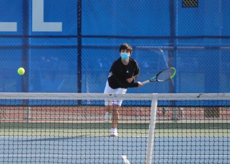 Caption for photo: Third singles player and freshman Charles Wait serves the ball. Wait went on to win his match 6-0, 6-0. Photo Courtesy of Jim Orr.