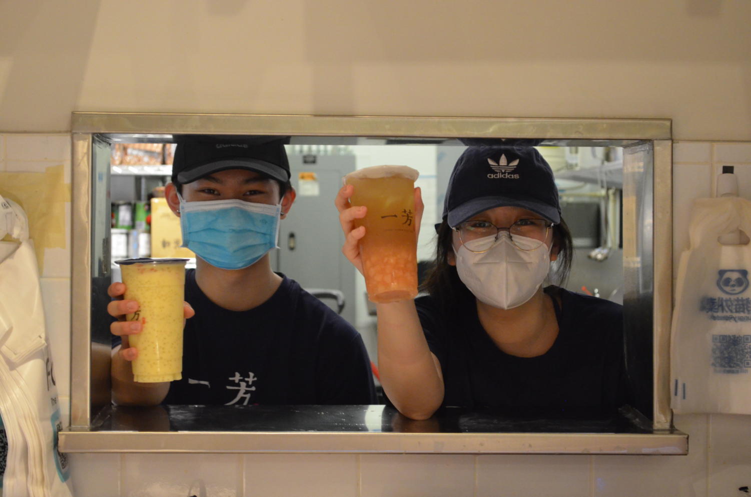 Yi+Fang+Taiwan+Fruit+Tea+Workers+distributing+their++peach+fruit+tea+and+mango+pomelo+sago+drinks.+