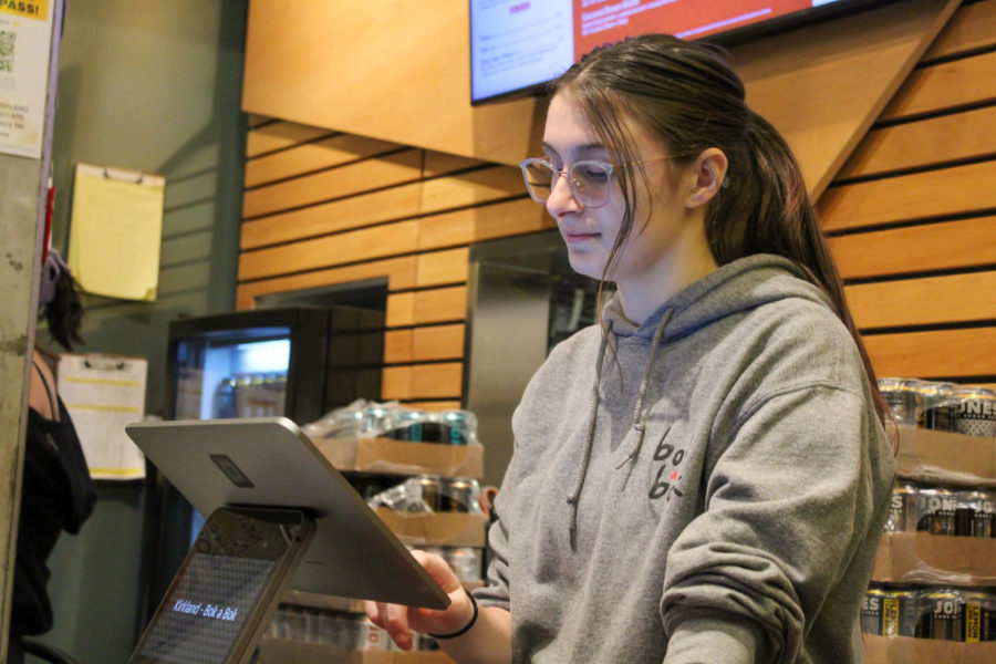 Senior Ellie Weibel (she/her) working at her current job at Bok a Bok. Weibel began working at Bok a Bok after quitting her previous job, where she said her manager was abusive.