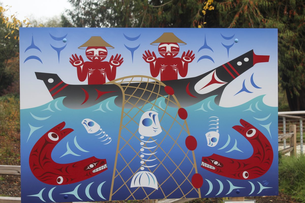 At Tl’awh-ah-dees Park in Kenmore, visitors see Salmon Scarcity, by Ty Juvinel. It is a Coast Salish design depicting fishermen, seals and salmon.