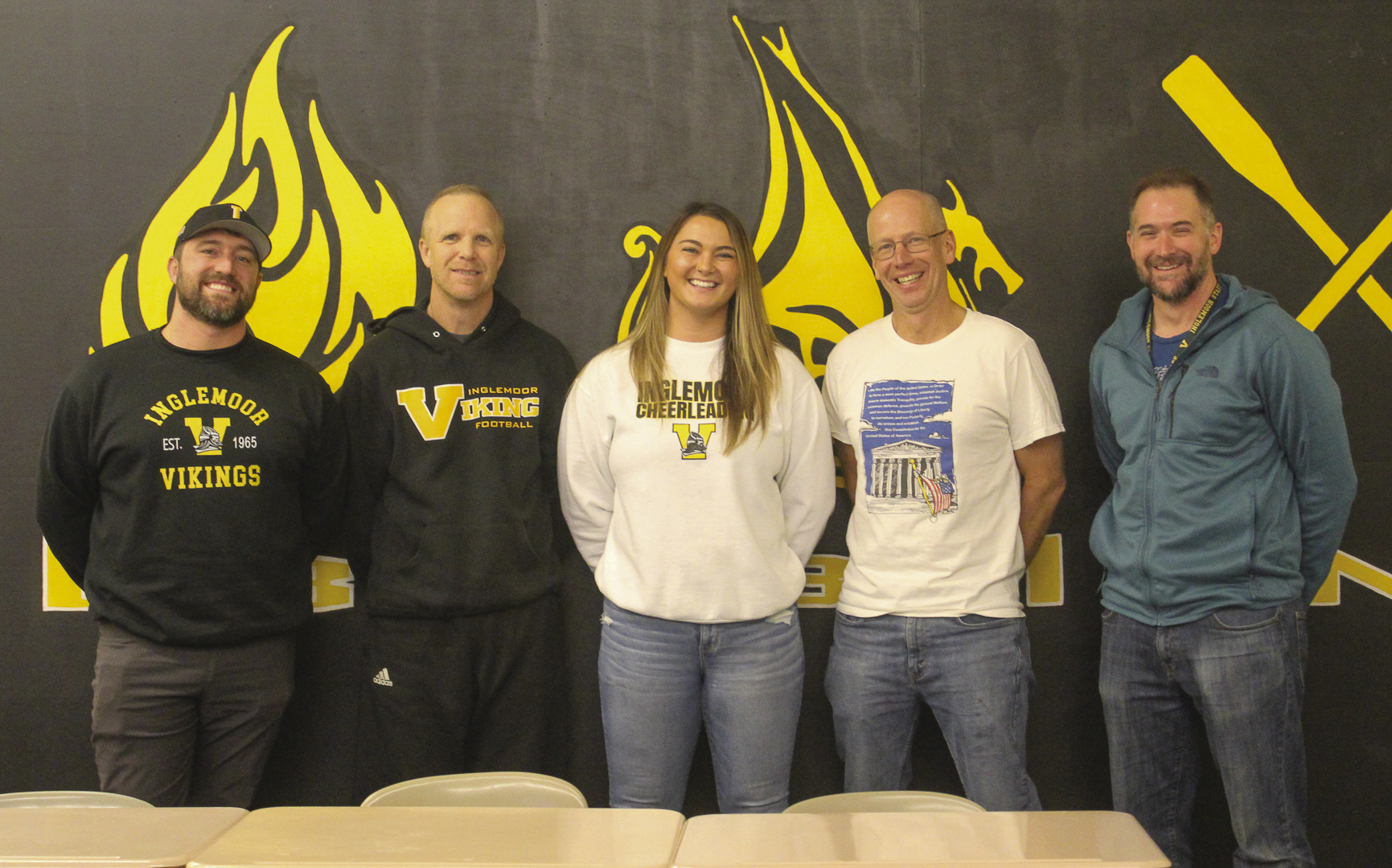 (From left to right) Head coaches Christian Hanna, Steve Hannan, Jason Metcalf-Lindenburger and David Wood pose with Athletic Director Kealey Stanich (middle) after the first girls’ flag football information meeting on Nov. 9. 