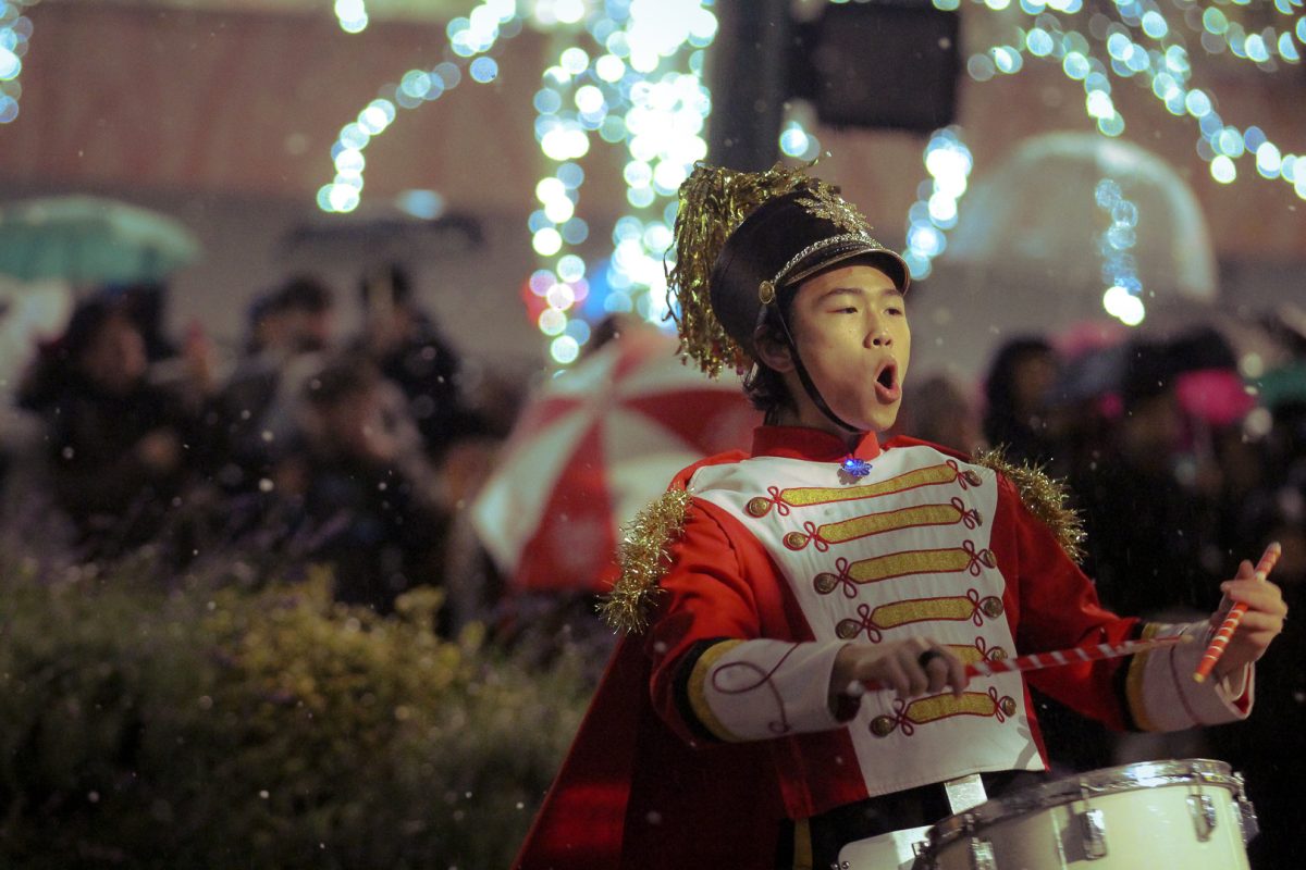 A drummer enjoys the festive energy of the crowd.  
