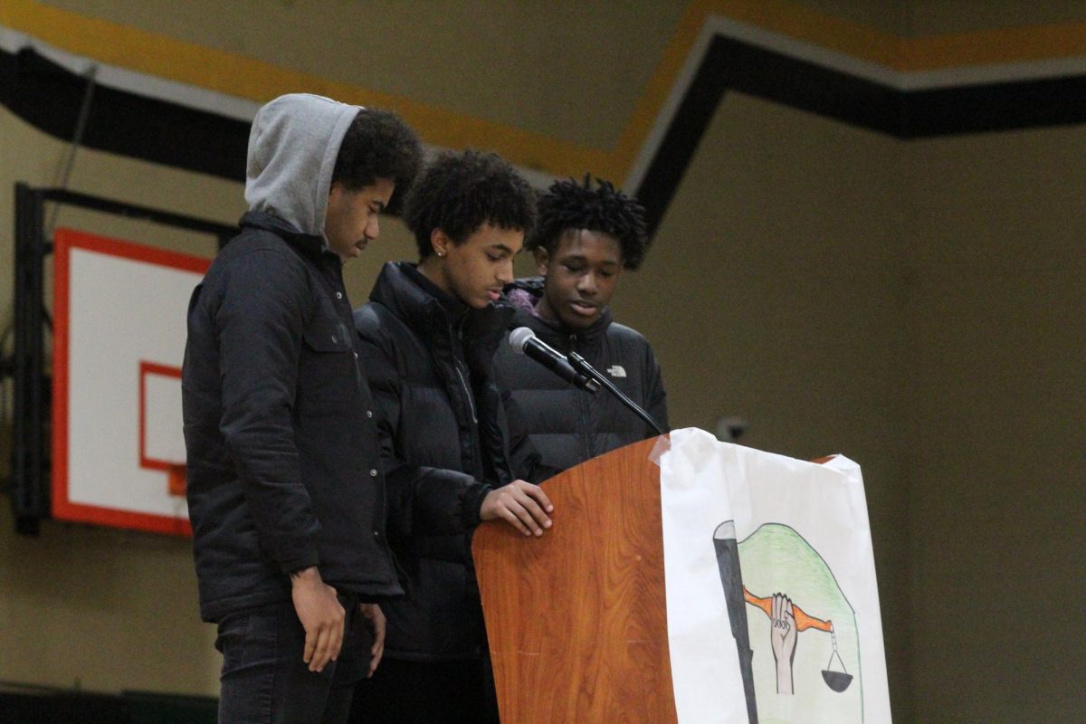 Black Student Union officers Cameron Jones, Rufael Estifanos and Louis Mitchell give the closing speech at the MLK assembly.