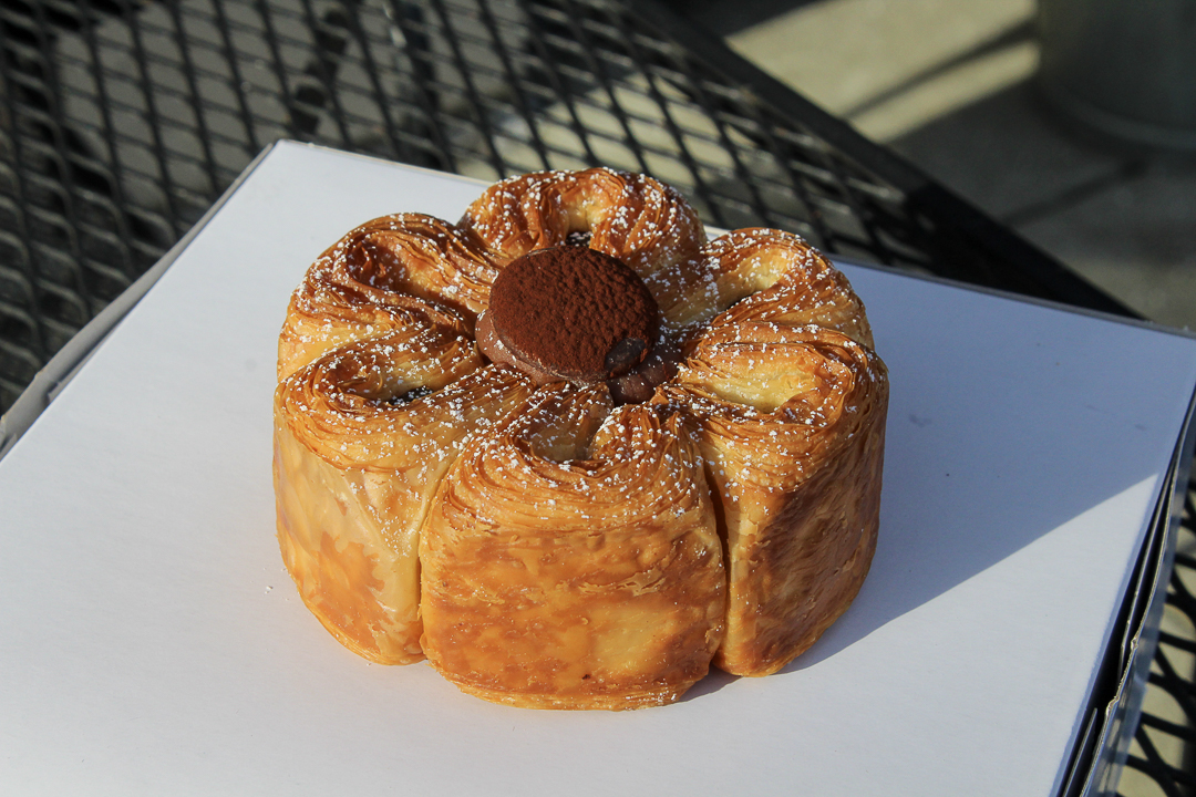 The pain au chocolat is a flower-shaped croissant with a chocolate ganache center and chocolate bits in each “petal.” 