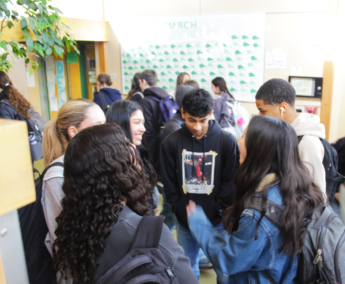 Students gather in clusters during passing period in the Sherwood’s Forest hallway on Mar. 7. “I like seeing my friends in the hallway because they always make me laugh,” junior Amalia Harb said.