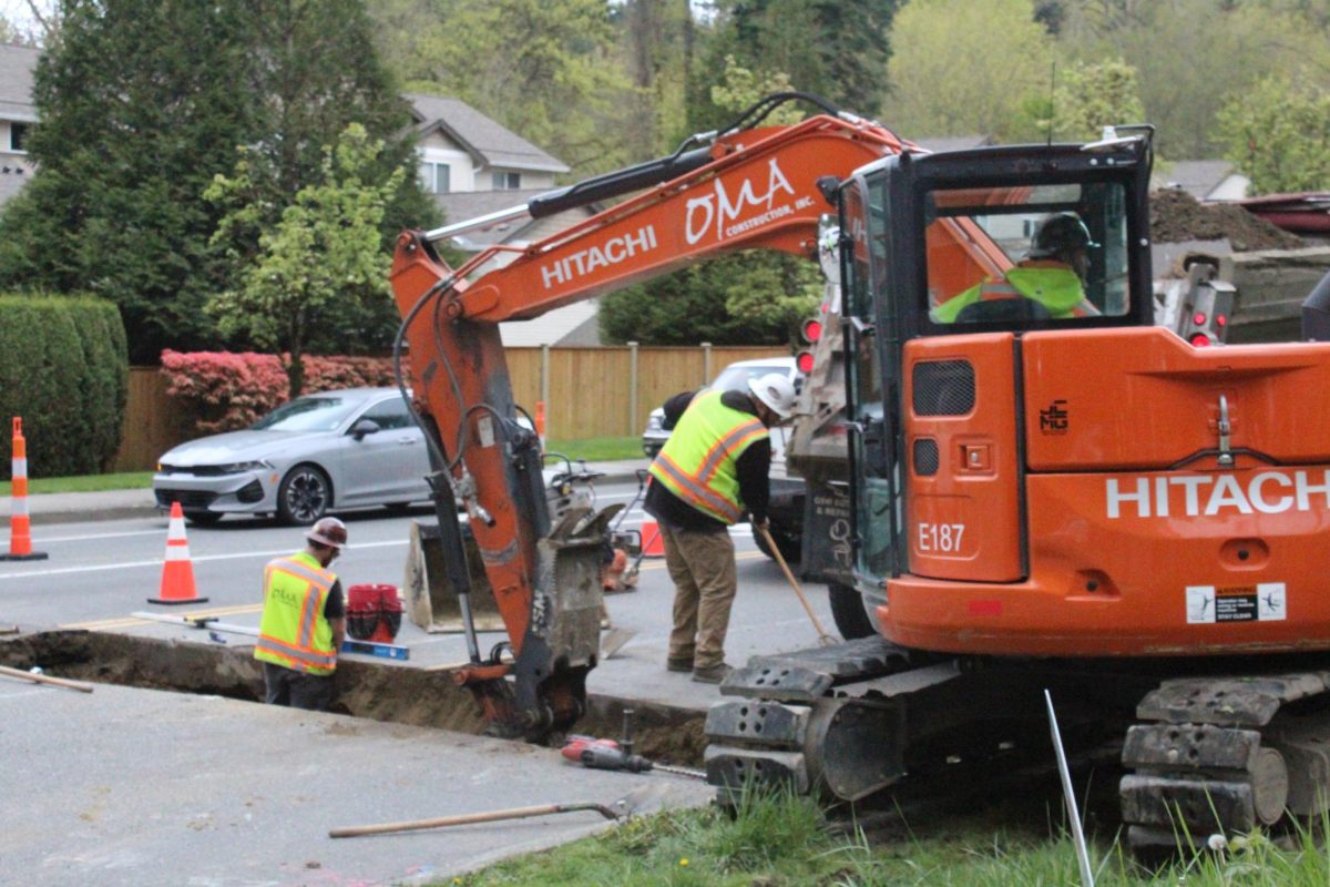 Contractors from OMA Construction install an underground pipe on the corner of Simond Road and 100th Avenue on April 12.