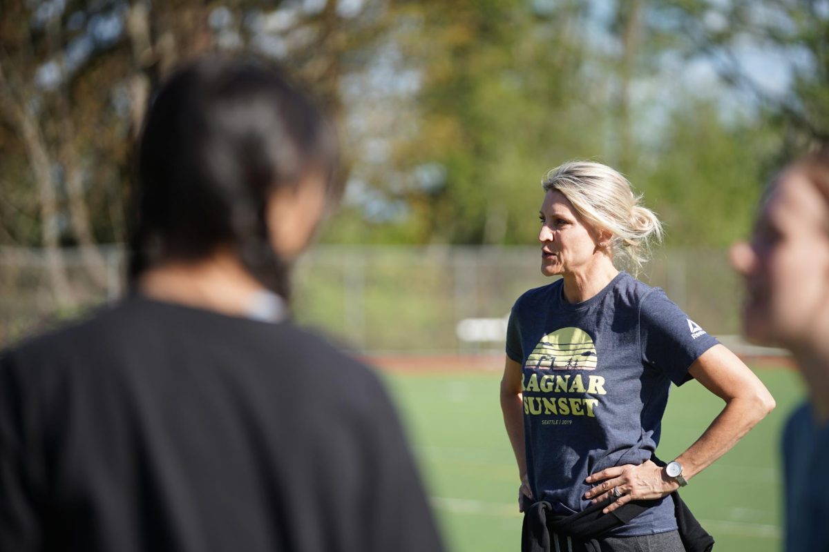 Track and field coach Kirsten Vesely instructs athletes during jumping drills at practice on April 18.