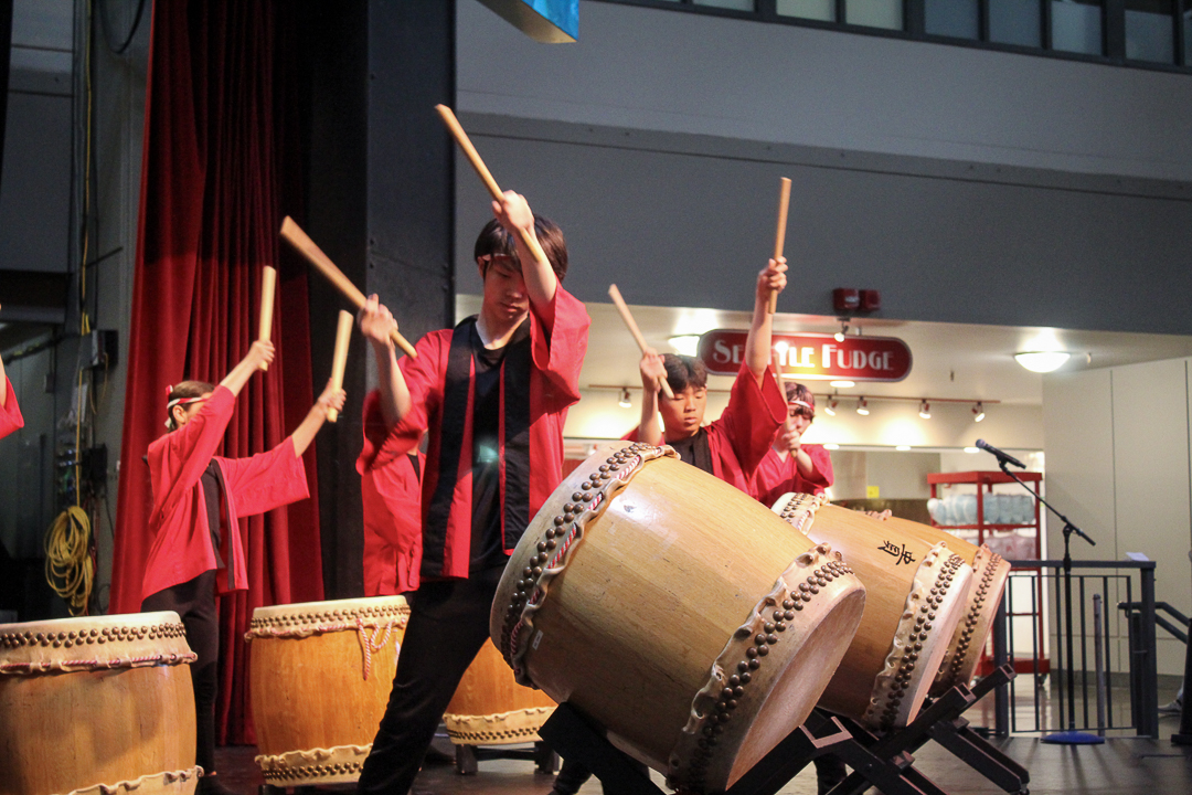 Musical youth group Kaze Daiko plays the Taiko drums onstage. Taiko drumming is a traditional Japanese practice that has a role in Buddhist and Shinto religious rituals.