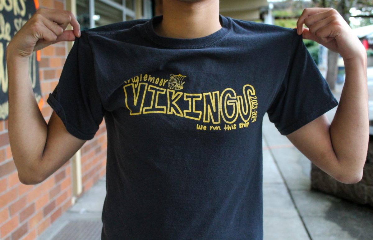 A student models a required Viking Shirt for PE class, showcasing the new dress code for the school year.