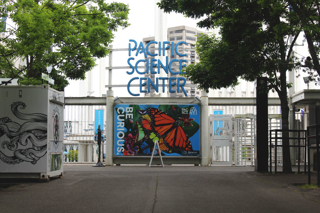 “Be curious!” PacSci’s motto is shown on top of exotic butterflies in a promotion for their butterfly exhibit outside the main courtyard. This butterfly exhibit is one of their signature offerings that has been kept open despite issues with their budget.