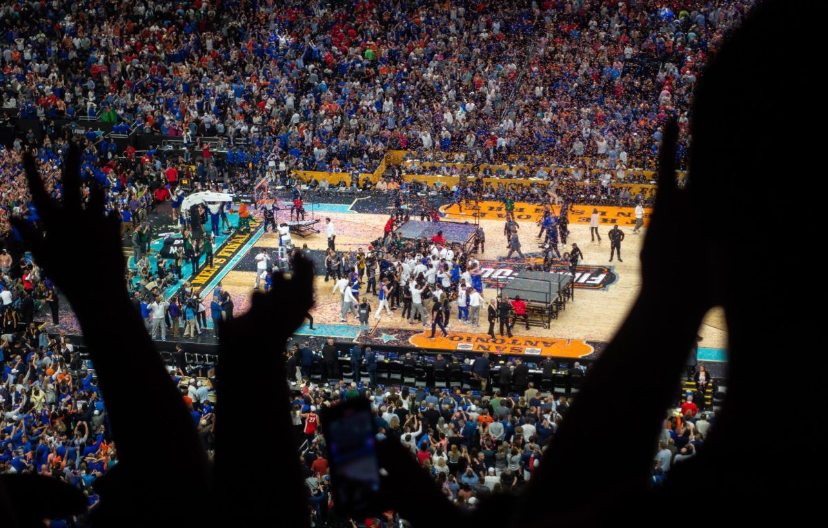 Florida fans go wild as they watch their team celebrate their national championship win.