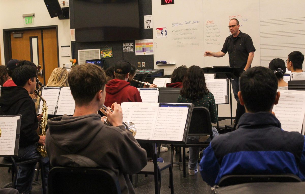 Fix conducts wind ensemble’s rehearsal of “Opening Night” in the band room.