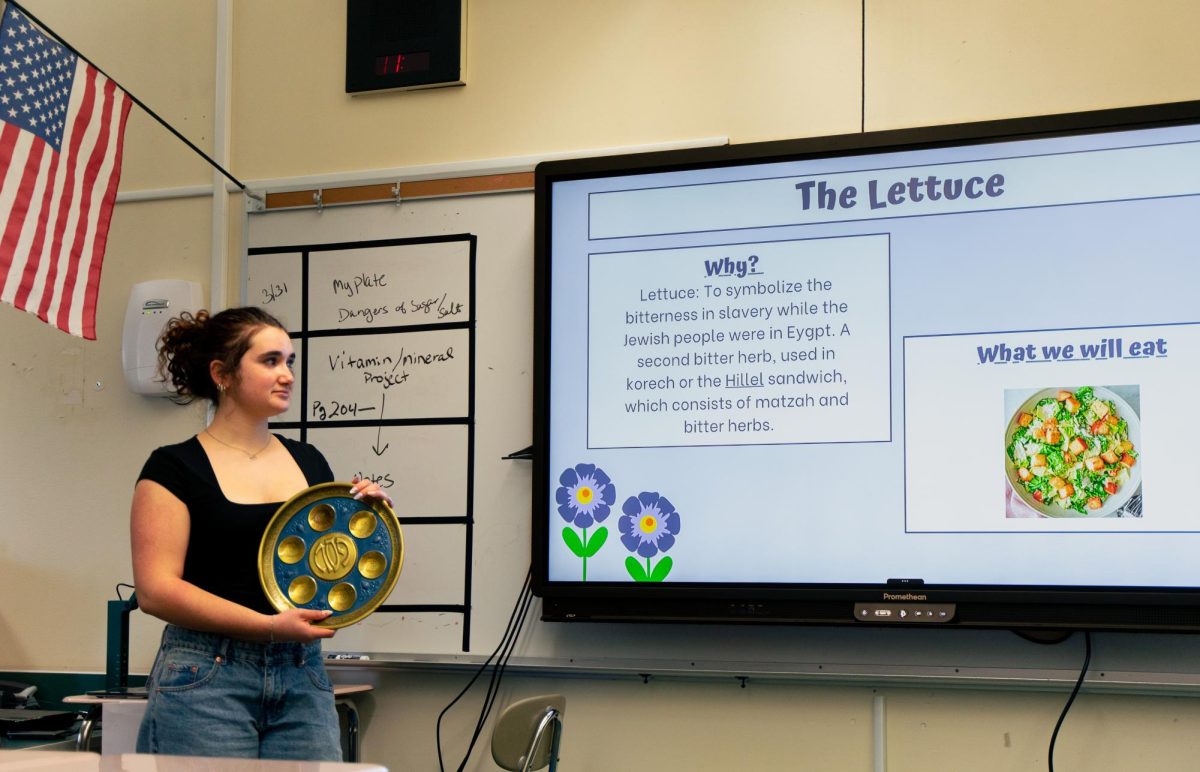 During the Jewish Student Union’s meeting about Passover, junior and co-president Emily Pranzini explains the symbolism behind each food on the Passover plate.