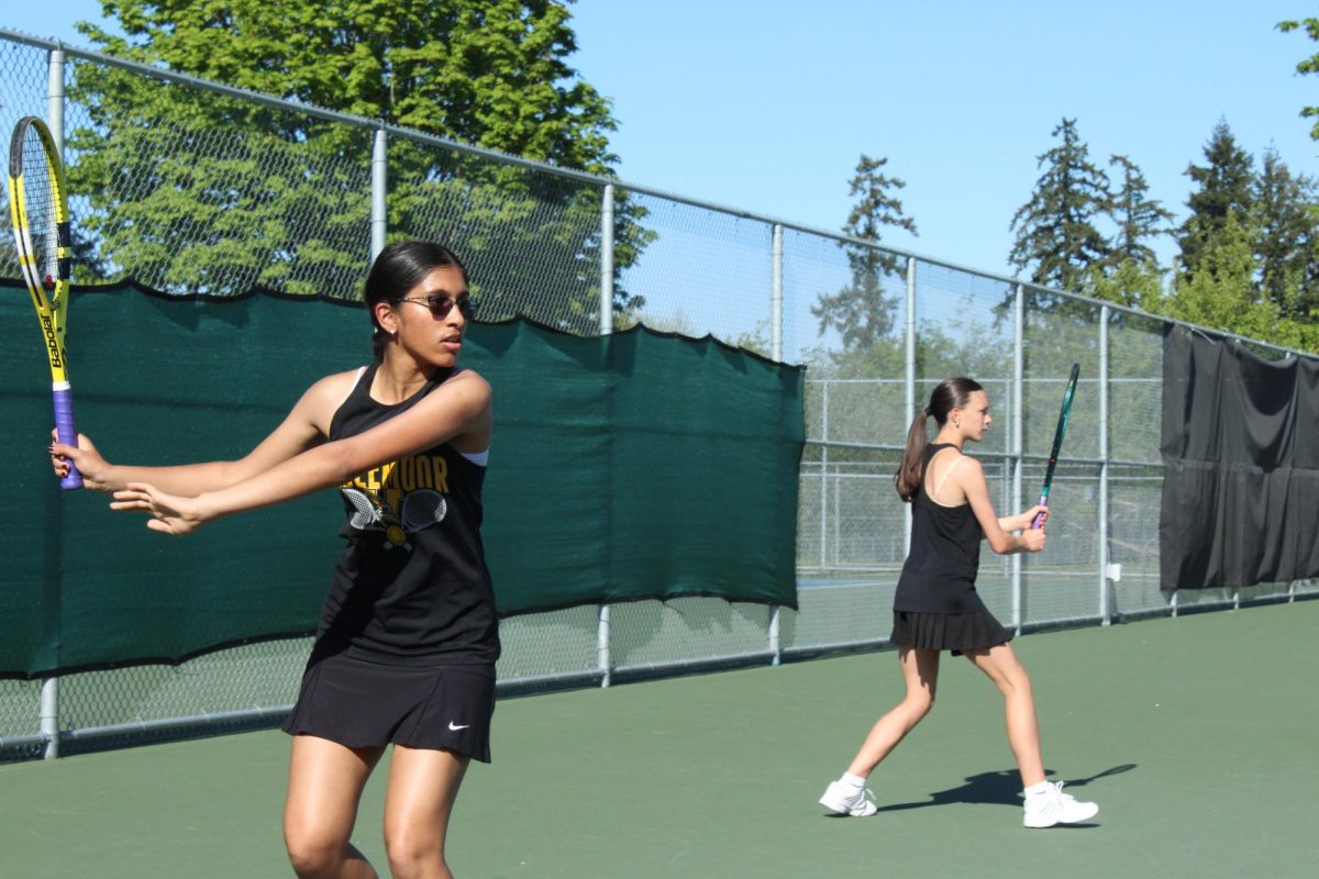 Freshmen Anya Rajyaguru and Sophie Oprea warm up before their game. 
