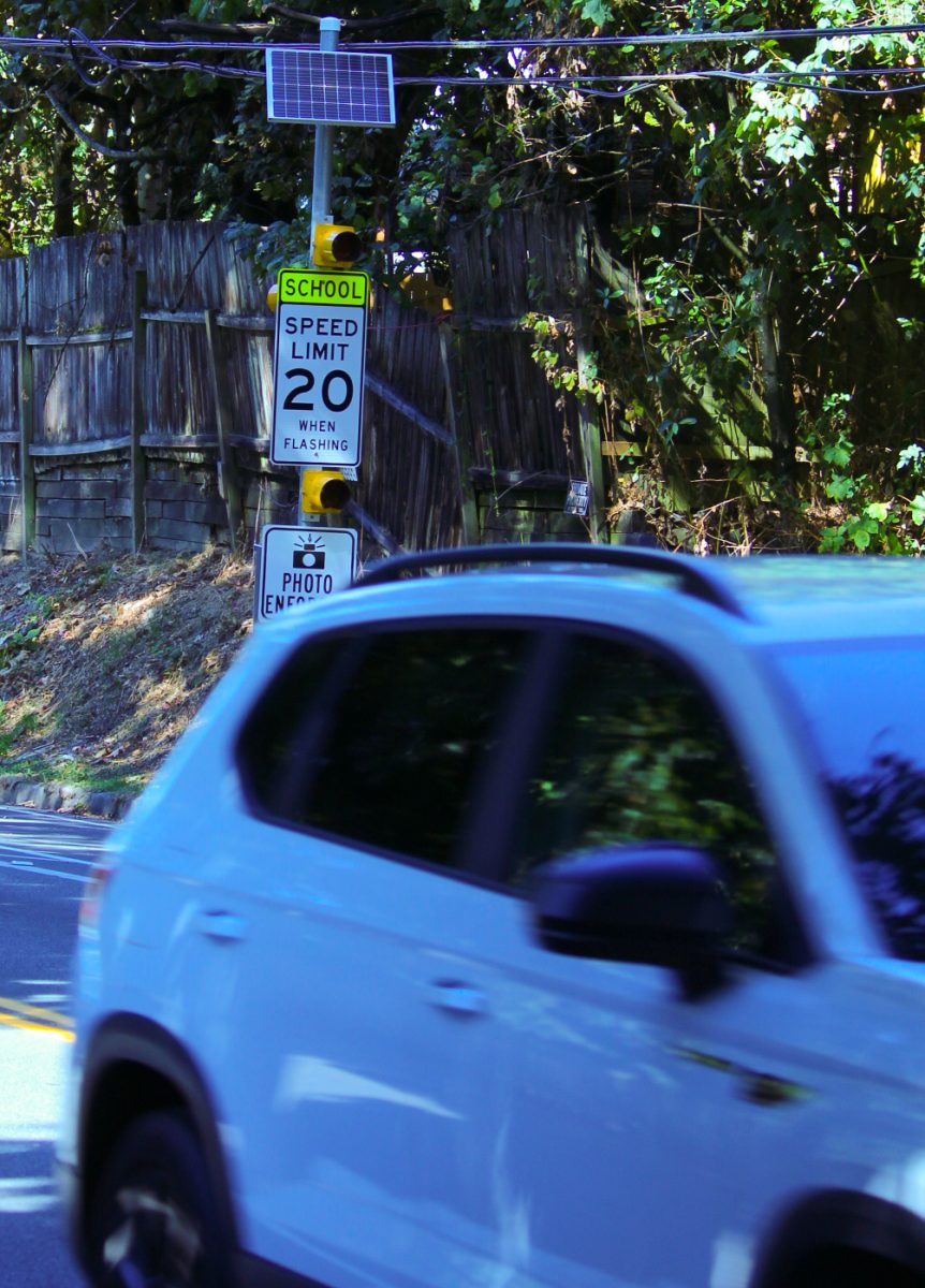 A vehicle drives past a school zone flasher sign just south of Inglemoor on Simonds Road. When the two lights on the sign are flashing, the new speed cameras enforce the speed limit of 20 mph. When the lights aren’t flashing, the cameras enforce a speed limit of 30 mph.