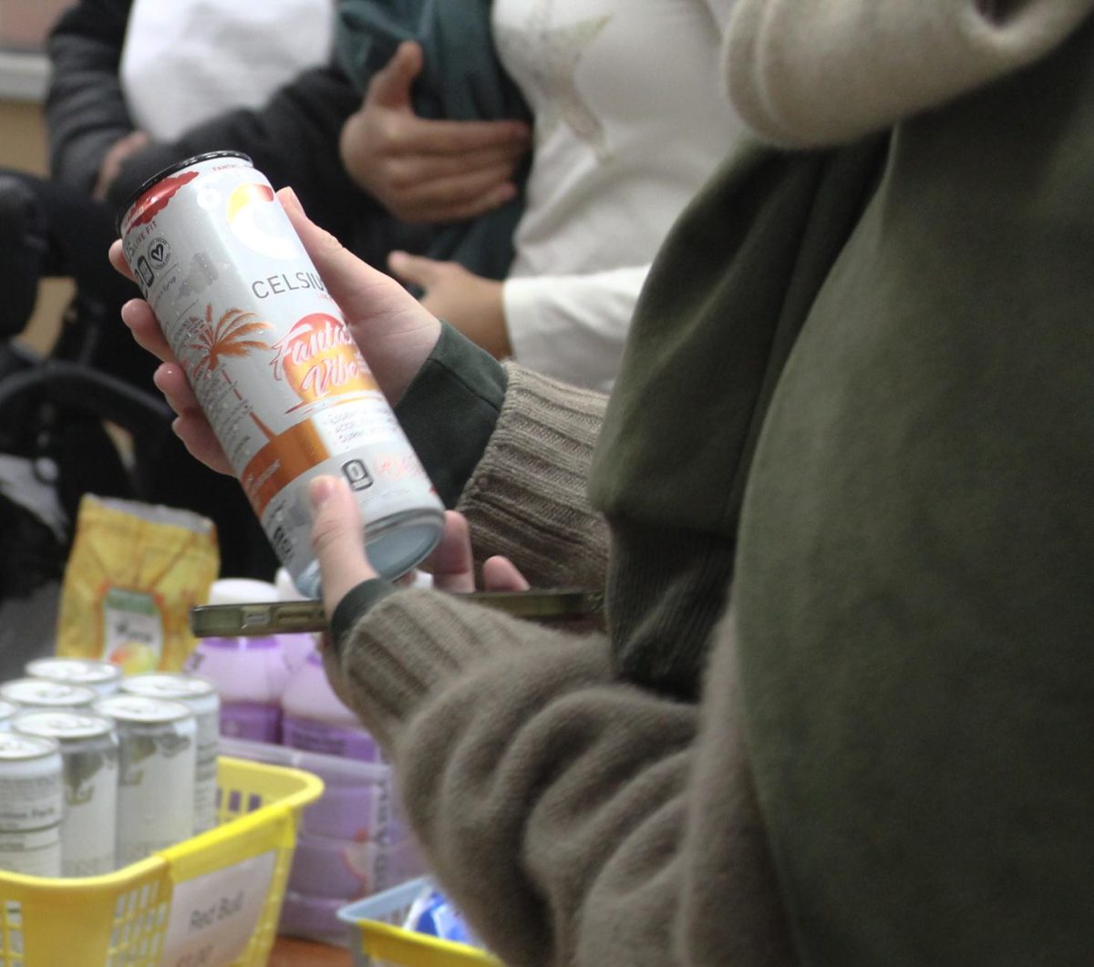 Senior Ari Walker (he/him) purchases an energy drink from the corner store during break. He said he buys three to four energy drinks every week to stay awake.