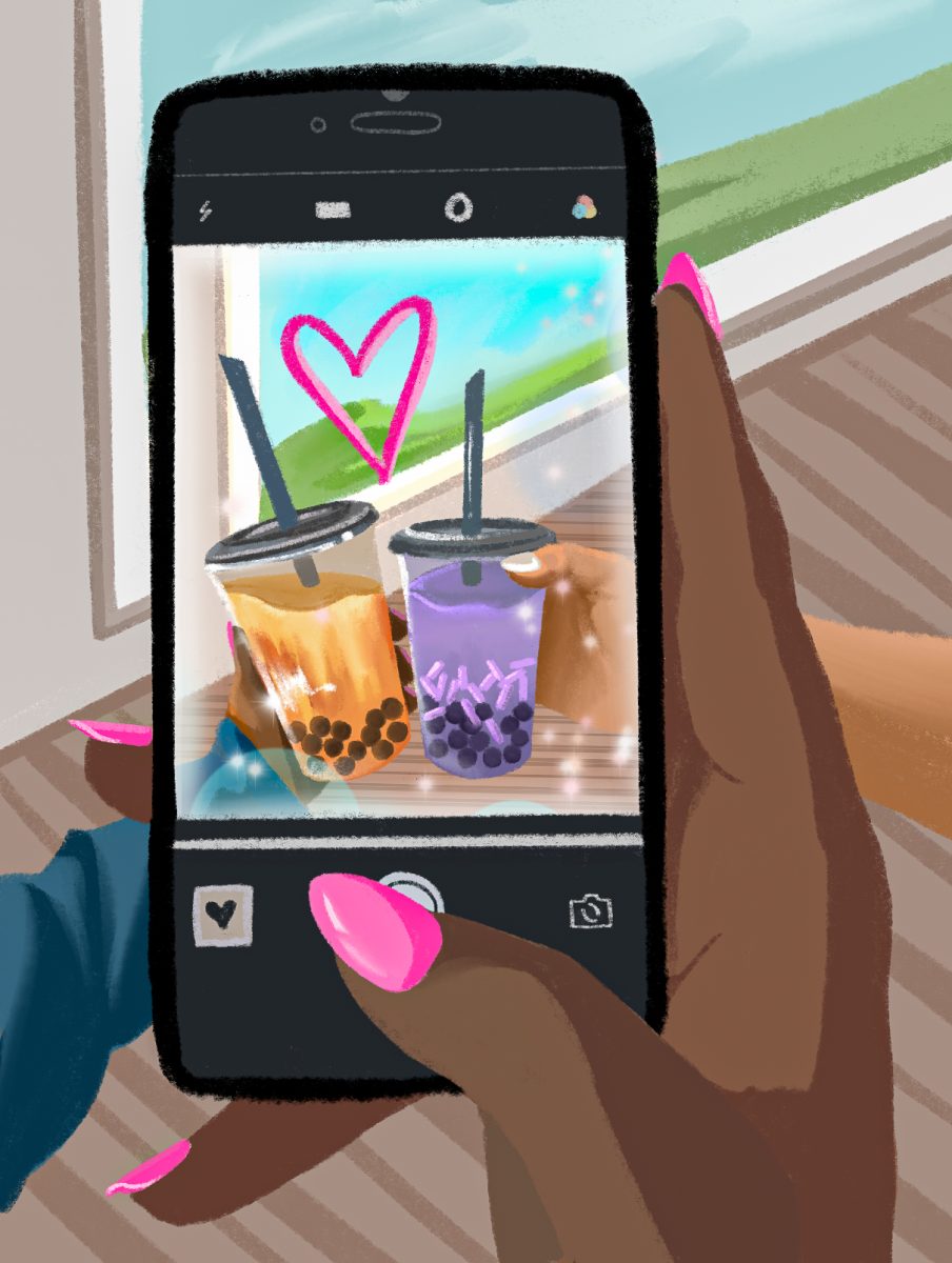 Two individuals hold boba drinks together while capturing the moment through a camera, reflecting how boba has become a social phenomenon.