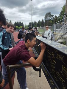 Making his mark on IHS’ future, junior Aaron Guo signs his name on the final beam placed as part of phase 1 construction. On May 7, students had the opportunity to sign the beam before it was put in place.
