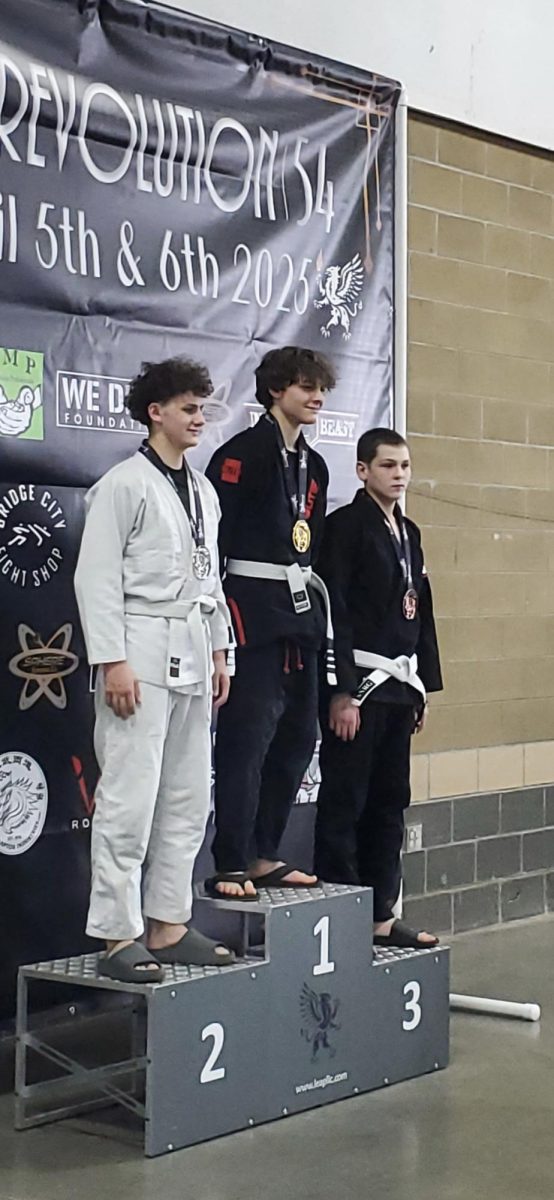 Lauany stands triumphantly after placing 1st and receiving a gold medal in the Revolution 54 Brazilian Jiu Jitsu competition on April 6. Photo courtesy of Kieran Launay.